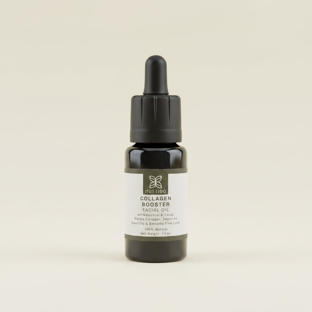 A small black dropper bottle labeled 'Collagen Booster Facial Oil' by The Skin Form, standing upright on a textured light gray surface.