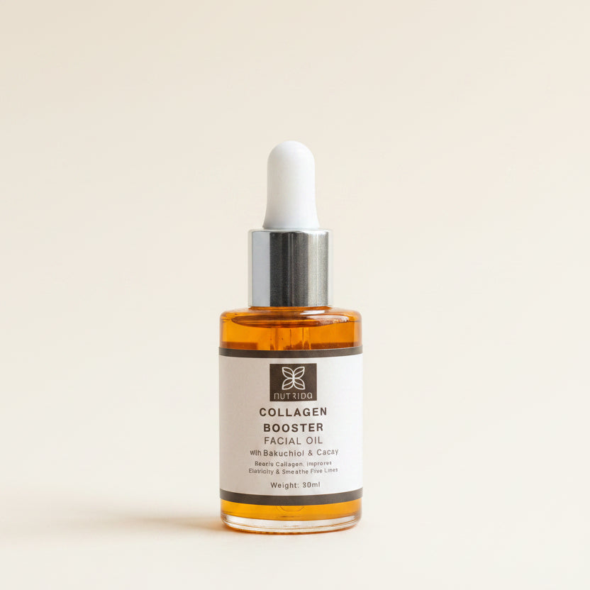 A 30ml dropper bottle of Nutripa Collagen Booster Facial Oil, filled with amber-colored oil, resting on a black surface in front of a window with beige curtains.