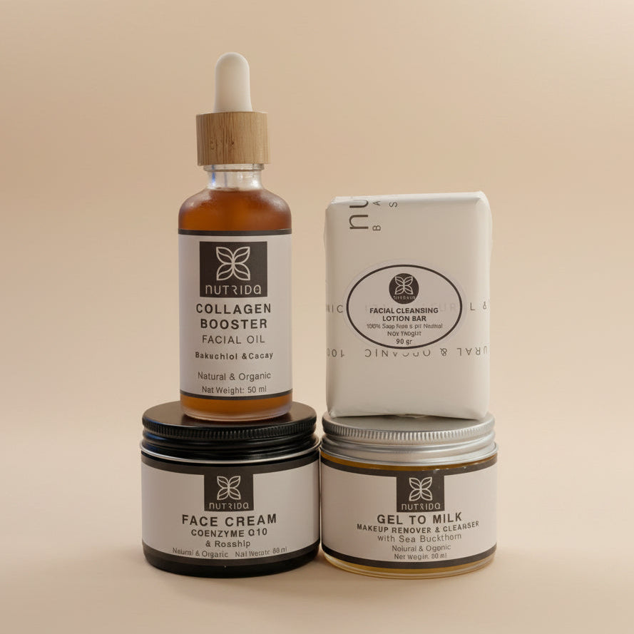 A set of four Nutrido skincare products arranged on a neutral fabric background: a Collagen Booster facial oil bottle, a Facial Cleansing Lotion Bar, a Face Cream jar, and a Gel to Milk makeup remover jar.