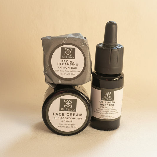 A skincare set from Nutridino on a light beige textured background, featuring a facial cleansing lotion bar in gray packaging, a jar of face cream with Coenzyme Q10, and a collagen booster facial oil in a dark dropper bottle.