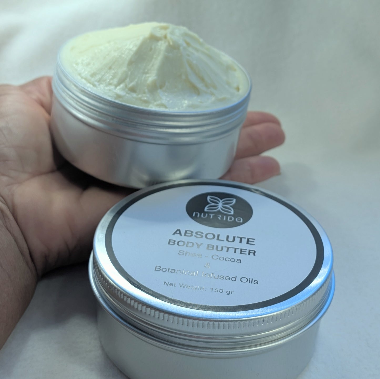 Nuttida Absolute Body Butter jar with lid on a white background