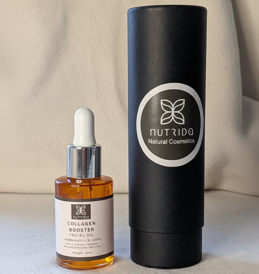 A bottle of Nutrido Natural Cosmetics Collagen Booster Facial Oil with a white dropper cap next to its tall black cylindrical packaging tube, set on a light beige fabric background.