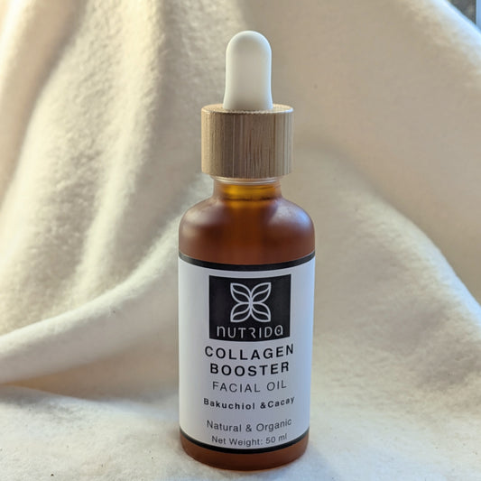 Bottle of Nutrida Collagen Booster Facial Oil on a beige fabric background