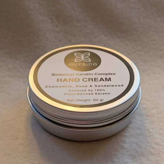 Hand cream container with visible branding on a brown background