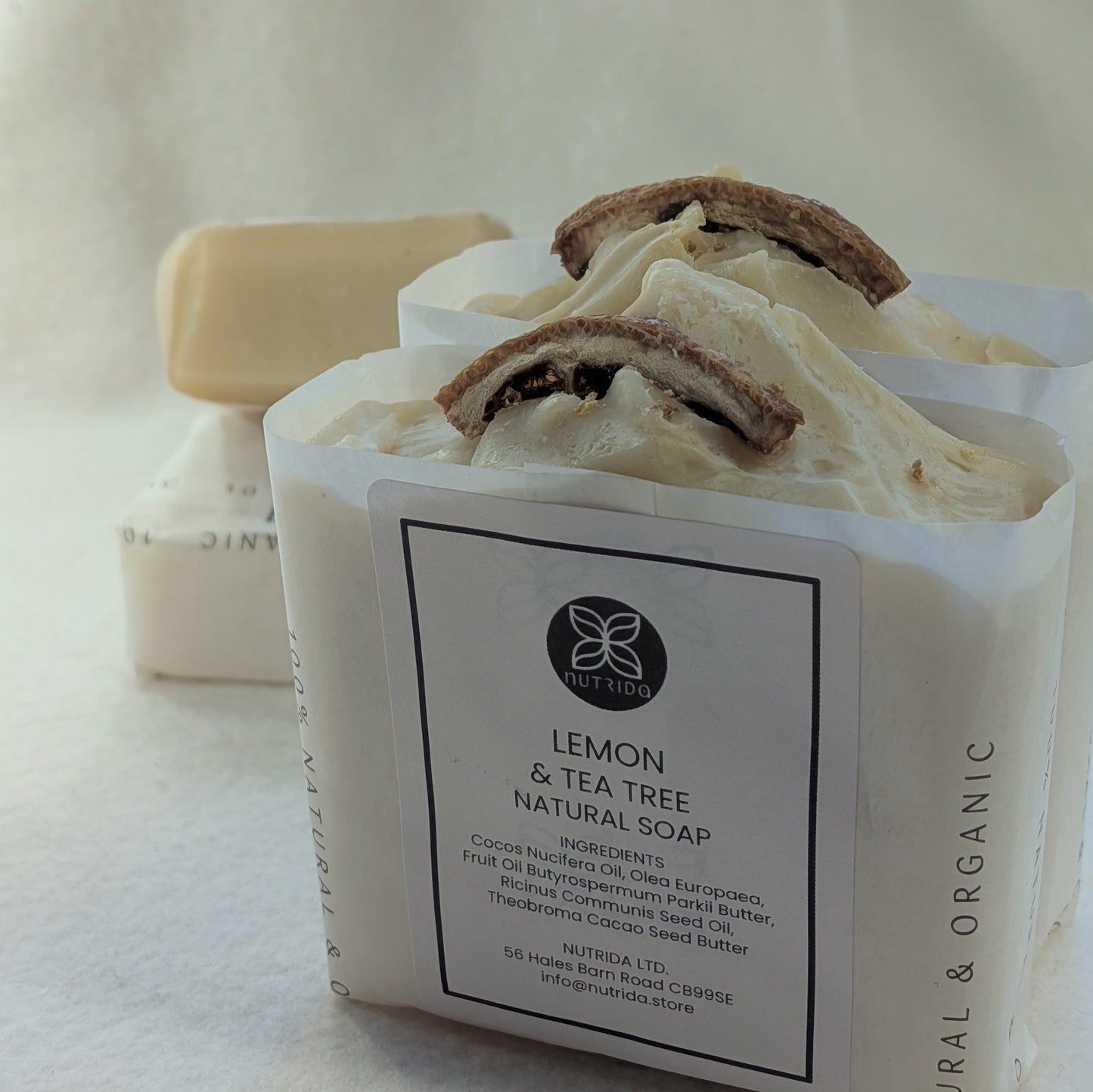Bar of lemon and tea tree natural soap with a visible label on a light background