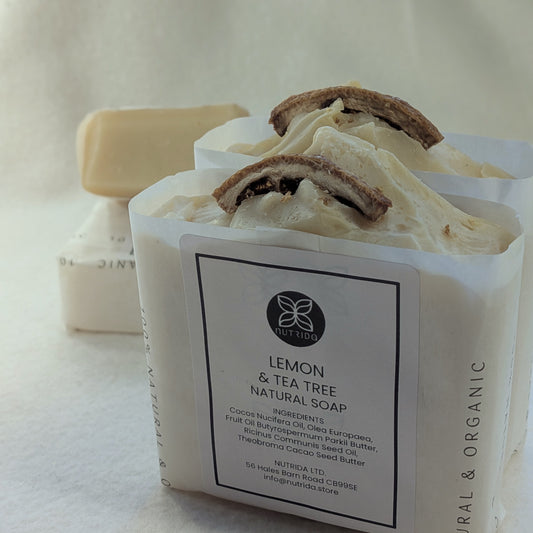 Bar of lemon and tea tree natural soap with a visible label on a light background