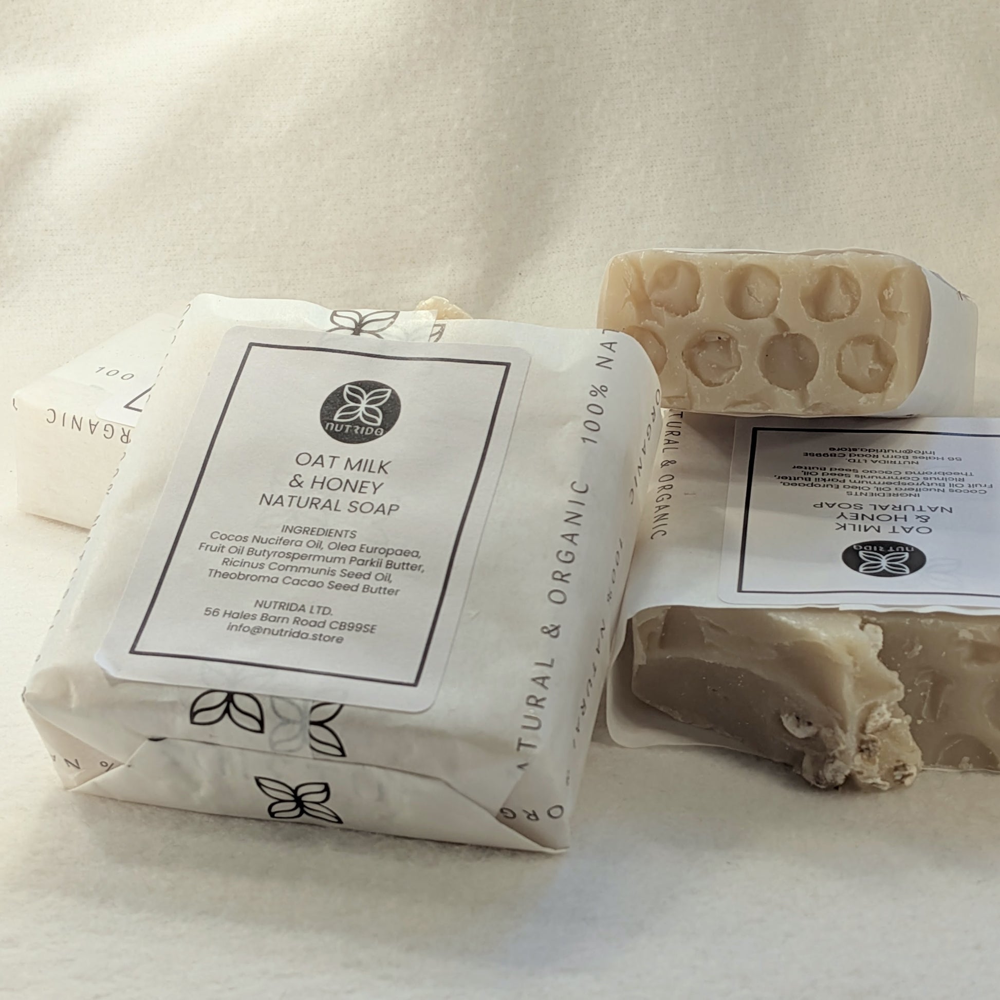 Oat milk and honey natural soap with packaging on a light background