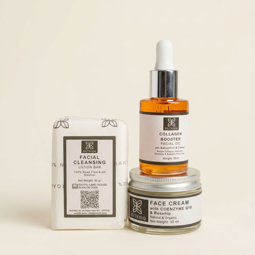 A skincare set from BR Facial Care arranged on a cream fabric surface, including a boxed facial cleansing lotion bar, an amber dropper bottle labeled facial booster serum, and a small jar of face cream.